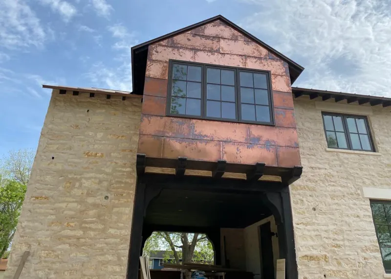 Copper metal panel facade on a stone building for Skylight Installation in Moses Lake