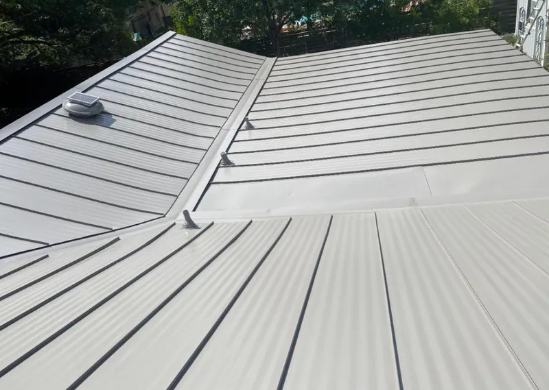 Solar attic fan installed on a metal roof for Roof Ventilation in Moses Lake
